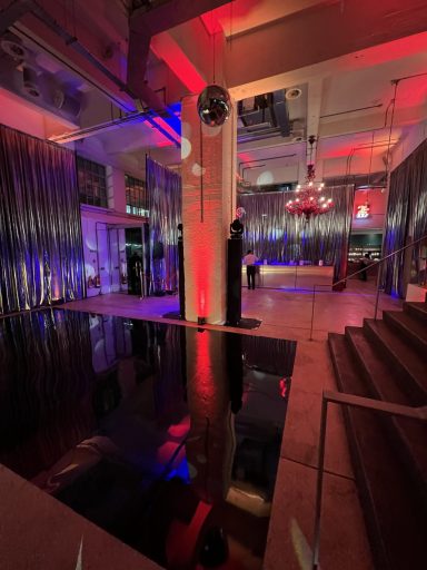 Silver lame drapes installed for an office Christmas party in London, creating a festive event backdrop